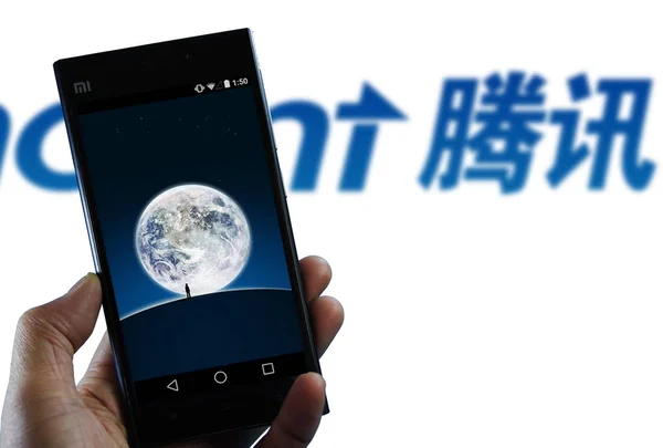 Ein Handynutzer zeigt die Messaging-App weixin, oder wechat, von tencent auf seinem Smartphone in der Stadt jinan in der ostchinesischen Provinz shandong, 8. Februar 2015. — Stockbild Ein Handynutzer Zeigt Die Messaging App Weixin Oder Wechat Von — Stockfoto