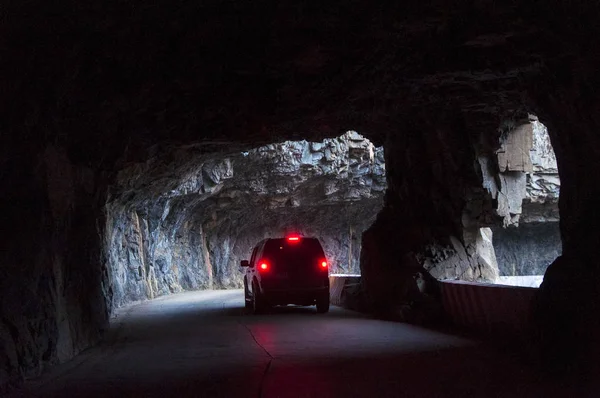 A car passes along a cliff tunnel in Jingdi village, Pingshun county, Changzhi city, north China\'s Shanxi province, 2 January 2016
