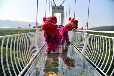 Dragon dance perform on Guangzhou's first glass-bottomed bridge in Guangzhou city, south China's Guangdong province, 23 January 2019 clipart