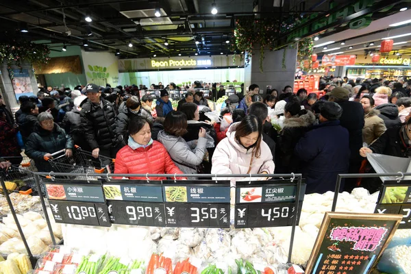 Chinese fans shop for peripheral products at a franchised store of