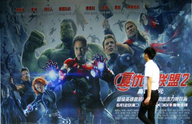 A moviegoer walks past a poster for the movie 