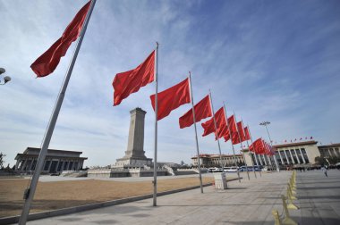 Red flags flutter in front of the Great Hall of the People during the preliminary conference for the third session of the 12th National People's Congress (NPC) in Beijing, China, 4 March 2015. clipart