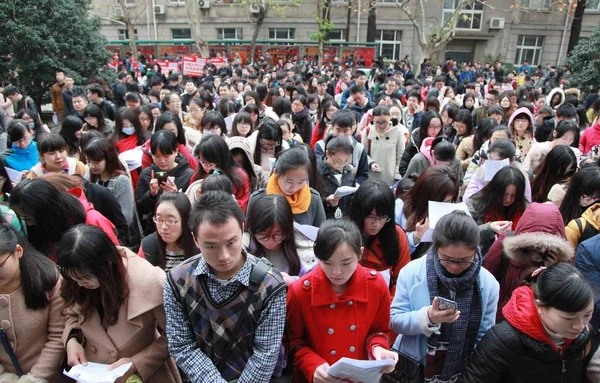 2014年11月30日 中国東部の江蘇省南京市で行われた2015年中国国家公務員試験に出席するために 試験場の外に中国人受験者が集まりました — ストック写真