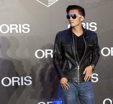 Hong Kong singer and actor Nicholas Tse poses during a promotional event for Swiss watch brand ORIS in Shanghai, China, 20 September 2015.   clipart