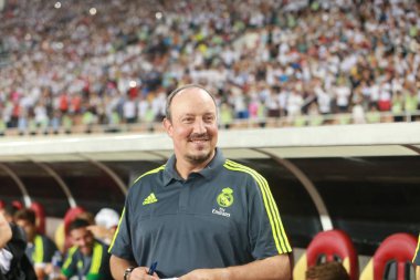 Head coach Rafael Benitez of Real Madrid watches his players competing against Inter Milan in a soccer match during the 2015 International Champions Cup China in Guangzhou city, south China's Guangdong province, 27 July 2015 clipart