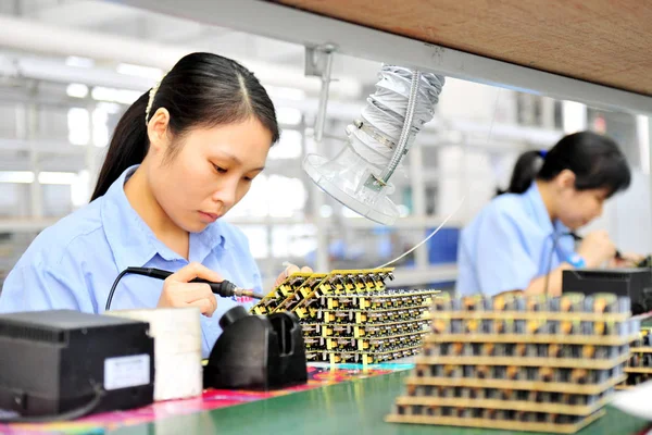 女性の中国人労働者は 2014 中国湖北省宜昌市の工場で電気製品を生産します — ストック写真