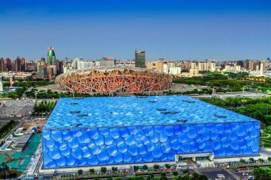 View of the Beijing National Stadium, back, also known as the Bird's Nest, and the Beijing National Aquatics Center, also known as the Water Cube, in the Olympic Green in Beijing, China, 27 May 2014. clipart