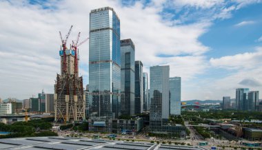 View of the Ping An International Finance Center (IFC) Tower under construction, left, in Shenzhen city, south China's Guangdong province, 25 September 2013. clipart
