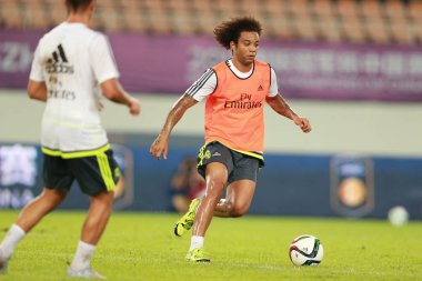 Marcelo Vieira, right, and teammates of Real Madrid take part in a training session in Guangzhou city, south China's Guangdong province, 26 July 2015. clipart