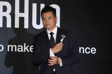 Singaporean actor Christopher Lee Ming-shun poses at a promotional event for Braun electric shaver in Taipei, Taiwan, 16 June 2015. clipart