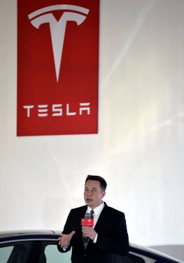 Tesla CEO Elon Musk speaks during a press conference for Tesla Firmware 7.0 in Beijing, China, 23 October 2015 clipart
