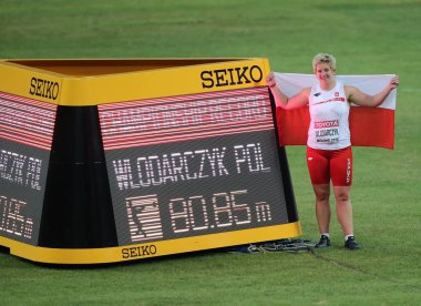 Poland's Anita Wlodarczyk poses for photos after winning the gold medal of the women's hammer throw and breaking the championship record during the Beijing 2015 IAAF World Championships at the National Stadium, also known as the Bird's Nest, in Beiji clipart