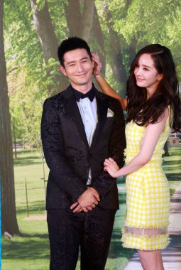 Chinese actress Yang Mi, right, and actor Huang Xiaoming smile during a press conference for their new movie 
