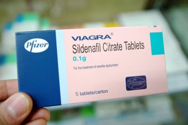 A man shows a box of Viagra sildenafil citrate tablets of Pfizer at a pharmacy in Shanghai, China, 19 November 2012 clipart