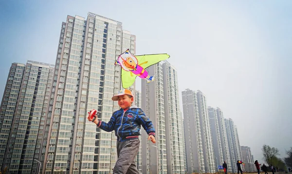 Young Chinese Boy Flies Kite Front Newly Built High Rise — Stock Photo, Image