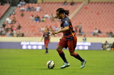 Edgar Davids of FPBarcelona Players dribbles against Inter Forever in a soccer match during the 2015 Winning League International Legend's Championship in Shanghai, China, 23 September 2015 clipart