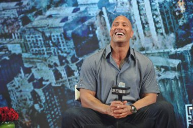 American actor Dwayne Johnson, also known by his ring name The Rock, laughs during a press conference for his movie 