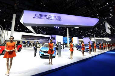 Hostesses pose in line at the stand of Shanghai Volkswagen, a joint venture between SAIC Motor and VW, during the 16th Shanghai International Automobile Industry Exhibition, also known as Auto Shanghai 2015, in Shanghai, China, 21 April 2015 clipart