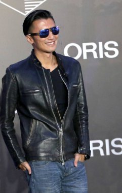 Hong Kong singer and actor Nicholas Tse smiles during a promotional event for Swiss watch brand ORIS in Shanghai, China, 20 September 2015.   clipart