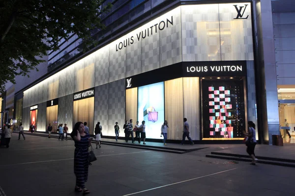 Customers walk past a Louis Vuitton (LV) store at a shopping mall in  Shanghai, China, 1 September 2015. At the beginning of 2013, a 65 year-old  stea Stock Photo - Alamy