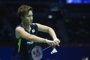 Kento Momota of Japan serves against Jan Ostergaard Jorgensen of Denmark in their quarterfinal match during the 2015 Sudirman Cup BWF World Mixed Team Championships in Dongguan city, south China's Guangdong province, 15 May 2015 clipart