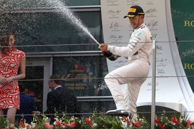 Britain's Lewis Hamilton of Mercedes sprays champagne to celebrate his victory during the award ceremony of the 2015 Formula 1 Chinese Grand Prix at the Shanghai International Circuit in Shanghai, China, 12 April 2015 clipart