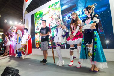 Showgirls dressed in cosplay costumes pose during the 11th China International Comics and Games Expo (CCG Expo 2015) in Shanghai, China, 9 July 2015 clipart