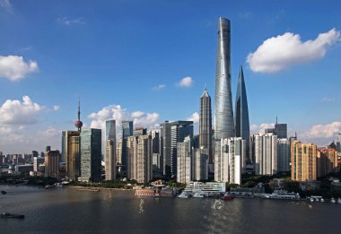 View of Huangpu River and the Lujiazui Financial District with the Oriental Pearl TV Tower, left tallest, the Shanghai Tower, right tallest, the Shanghai World Financial Center, right second tallest, the Jinmao Tower and other skyscrapers and high-ri clipart