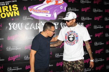 American singer and actor Chris Brown, right, talks with Gilbert Yeung Kei-lung, the son of Hong Kong entertainment tycoon Albert Yeung Sau-shing, at a promotional event at Dragon-i bar in Hong Kong, China, 26 July 2015.