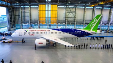 China's first homemade large passenger jet C919 is being pulled out of a hangar during an offline ceremony at the final assembly plant of COMAC (Commercial Aircraft Corporation of China) in Pudong, Shanghai, China, 2 November 2015 clipart