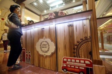 A customer is seen at the JENNY BAKERY store in the Global Harbor shopping mall in Putuo District, Shanghai, China, 26 October 2015 clipart