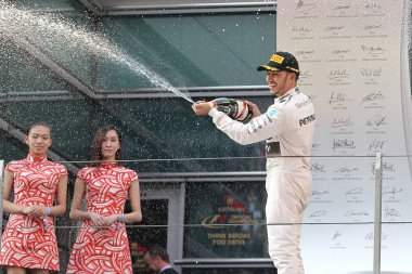 Britain's Lewis Hamilton of Mercedes sprays champagne to celebrate his victory during the award ceremony of the 2015 Formula 1 Chinese Grand Prix at the Shanghai International Circuit in Shanghai, China, 12 April 2015 clipart