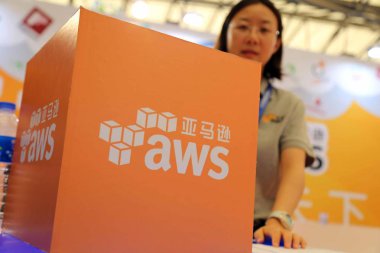 A Chinese employee is seen at the stand of AWS (Amazon Web Services) during the 13th China Digital Entertainment Expo, also known as ChinaJoy 2015, in Shanghai, China, 30 July 2015. clipart