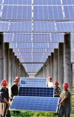 Chinese workers install solar panels at a photovoltaic power station in Hengfeng county, Shangrao city, east China's Jiangxi province, 28 March 2015 clipart