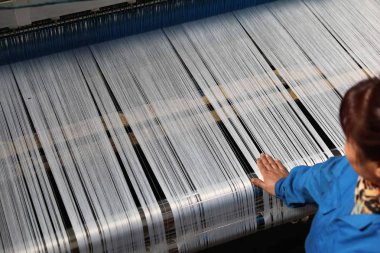 female Chinese worker handles production of plastics at a factory in Hangzhou city, east China's Zhejiang province, 21 January 2019