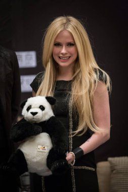 Canadian singer Avril Lavigne poses with a giant panda stuffed toy during a press conference for her China Tour concert in Shanghai, China, 21 February 2014.