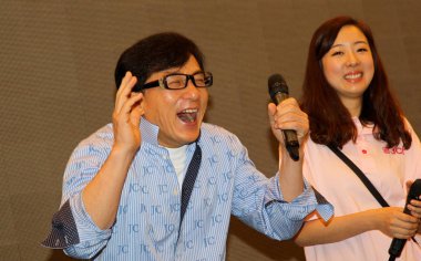Hong Kong actor Jackie Chan, left, laughs during the opening ceremony of the Jackie Chan Film Gallery in Changfeng Ecological Business Hub in Shanghai, China, 9 April 2014 clipart