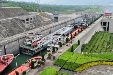 Boats sail through a ship lock of the Three Gorges Dam in Yichang city, central Chinas Hubei province, 17 May 2013 clipart