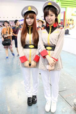 Chinese showgirls dressed in cosplay costumes pose during the 2014 China International Cartoon and Game Expo, known as CCG Expo 2014, in Pudong, Shanghai, China, 10 July 2014. clipart