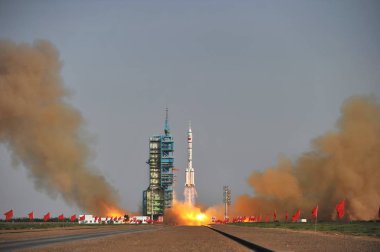 A Long March 2F (CZ-2F) carrier rocket carrying the Shenzhou-9 (Shenzhou IX) spacecraft with three Chinese astronauts blasts off at the Jiuquan Satellite Launch Center near Jiuquan city, northwest Chinas Gansu province, 16 June 2012 clipart