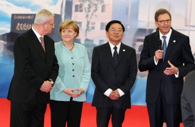 Dr. Jochem Heizmann, right, President and CEO of Volkswagen China, speaks next to German Chancellor Angela Merkel, second left, Volkswagen CEO Martin Winterkorn, left, and FAW Group Chairman Xu Jianyi as they visit the auto plant of FAW-Volkswagen in clipart