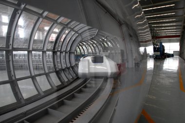 A super-maglev vehicle runs on a track during the trial run at Southwest Jiaotong University in Chengdu city, southwest Chinas Sichuan province, 2 May 2014 clipart