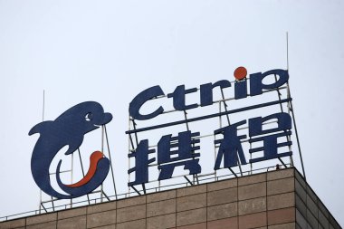 A signboard of Ctrip is seen at the top of office building of Chinese online travel agency Ctrip in Shanghai, China, 26 March 2014 clipart
