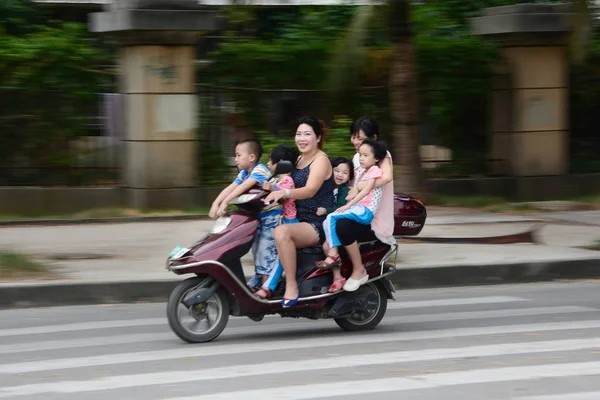 File Two Women Four Young Kids Ride Electric Bike Road — стоковое фото