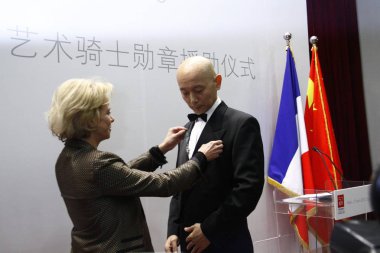 Frederique Bredin, left, President of CNC (Centre National du Cinema et de limage animee or the National Center of Cinematography and the moving image), awards Chinese actor Ge You Chevalier dans lOrdre des Arts et des Lettres (Order of Arts and Lett clipart