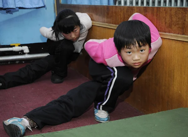 Młoda Chińska Praktyka Dzieci Stwarza Jazda Łyżwach Podczas Sesji Treningowej — Zdjęcie stockowe
