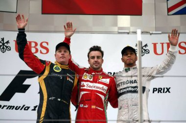 (From left) Finnish F1 driver Kimi Raikkonen of Lotus, Spanish F1 driver Fernando Alonso of Ferrari and British F1 driver Lewis Hamilton of Mercedes wave after the 2013 Formula One Chinese Grand Prix at the Shanghai International Circuit in Shanghai, clipart