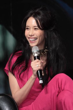 Hong Kong singer Karen Mok laughs during the press conference of her new Jazz album in Taipei, 18 January 2013.  *** Local Caption ***   clipart