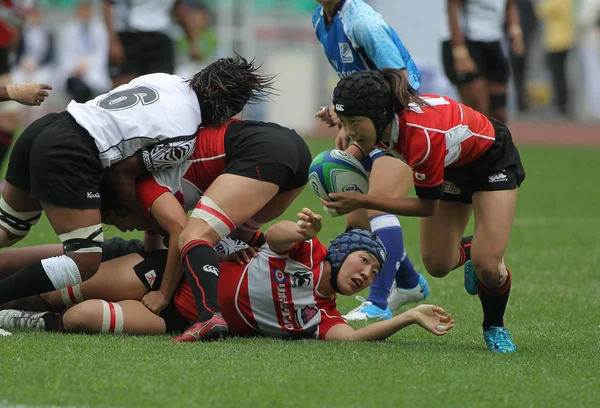 stock image Players of Japan (red) and Fiji (white) compete in their match during the 2013 IRB Womens Sevens World Series in Guangzhou city, south Chinas Guangdong province, 31 March 2013.