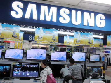Customers buy Samsung LCD and LED televisions at a home appliances store in Nantong city, east Chinas Jiangsu province, 16 October 2011 clipart